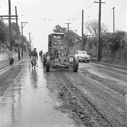 g. Views of workmen re surfacing the road. Machinery and motor vehicles
