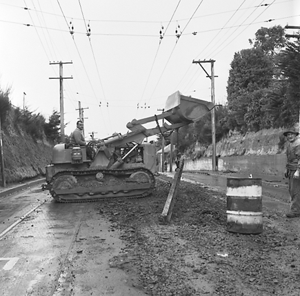 i. Views of workmen re surfacing the road. Machinery and motor vehicles