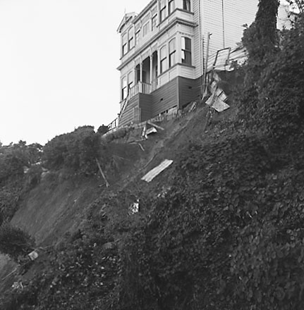 a.Two storey wooden dwelling affected by slip