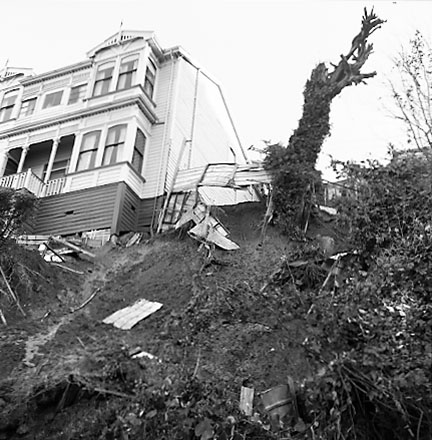 b.Two storey wooden dwelling affected by slip