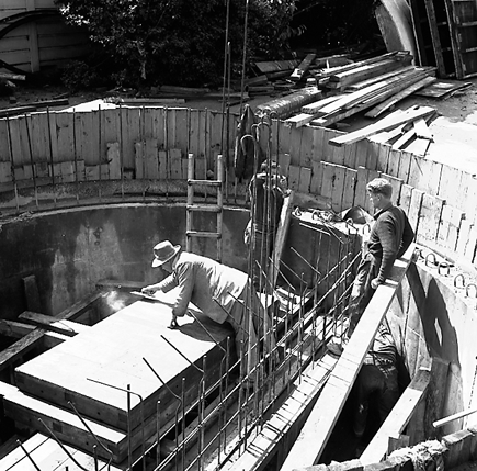 a. Workmen in base of underground pumping station, interior