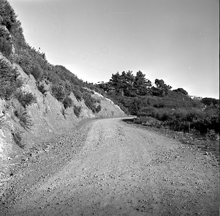 f. views of construction work in progress, workmen, equipment, graders, front end loaders, trucks, dwellings in the background