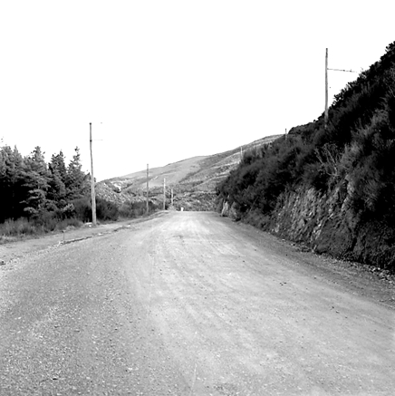 k. views of construction work in progress, workmen, equipment, graders, front end loaders, trucks, dwellings in the background