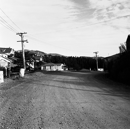 m. views of construction work in progress, workmen, equipment, graders, front end loaders, trucks, dwellings in the background