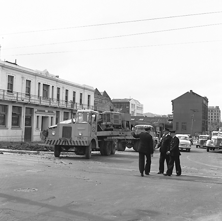 a. Various views of Taranaki Street road works. Includes Traffic Offices directing traffic, the Panama Hotel on the corner of Vivian Street, Wright Stevenson Building, workmen and equipment, and motor vehicle