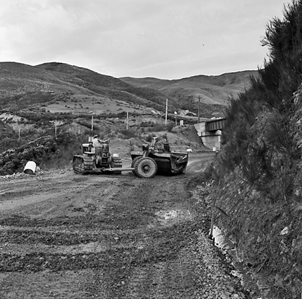 o. views of construction work in progress, workmen, equipment, graders, front end loaders, trucks, dwellings in the background