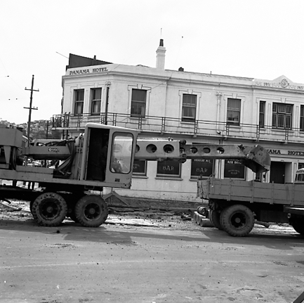 b. Various views of Taranaki Street road works. Includes Traffic Offices directing traffic, the Panama Hotel on the corner of Vivian Street, Wright Stevenson Building, workmen and equipment, and motor vehicle