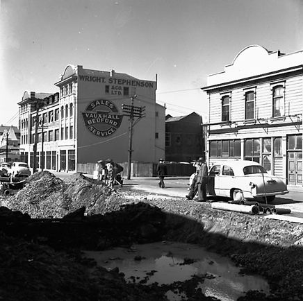 f. Various views of Taranaki Street road works. Includes Traffic Offices directing traffic, the Panama Hotel on the corner of Vivian Street, Wright Stevenson Building, workmen and equipment, and motor vehicle