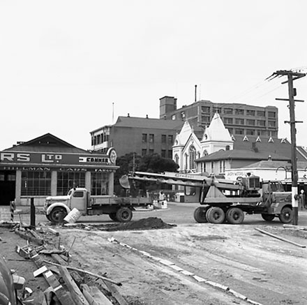 k. Various views of Taranaki Street road works. Includes Traffic Offices directing traffic, the Panama Hotel on the corner of Vivian Street, Wright Stevenson Building, workmen and equipment, and motor vehicle