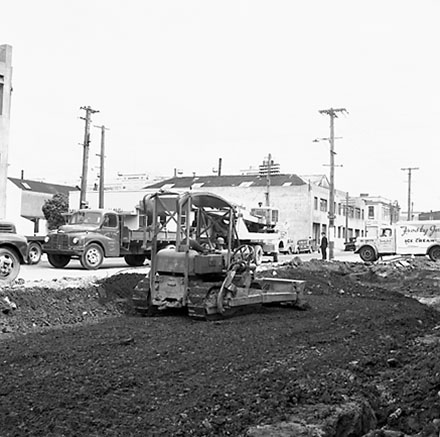 l. Various views of Taranaki Street road works. Includes Traffic Offices directing traffic, the Panama Hotel on the corner of Vivian Street, Wright Stevenson Building, workmen and equipment, and motor vehicle