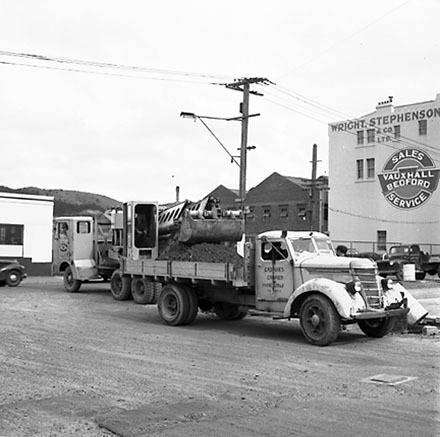 m. Various views of Taranaki Street road works. Includes Traffic Offices directing traffic, the Panama Hotel on the corner of Vivian Street, Wright Stevenson Building, workmen and equipment, and motor vehicle