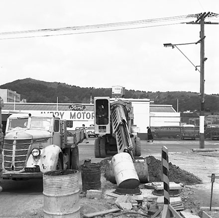 n. Various views of Taranaki Street road works. Includes Traffic Offices directing traffic, the Panama Hotel on the corner of Vivian Street, Wright Stevenson Building, workmen and equipment, and motor vehicle