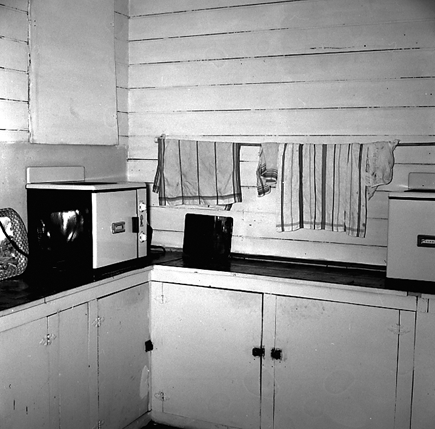 c. Interior and exterior views of a two storey wooden dwelling. Faulty plumbing and wiring