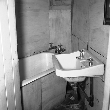 e. Interior and exterior views of a two storey wooden dwelling. Faulty plumbing and wiring