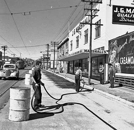 c. Workmen in front of 42 to 48 Adelaide Road, billboard for Cremolta to the right