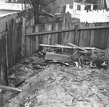 i. Interior and exterior views of a two storey wooden dwelling. Faulty plumbing and wiring