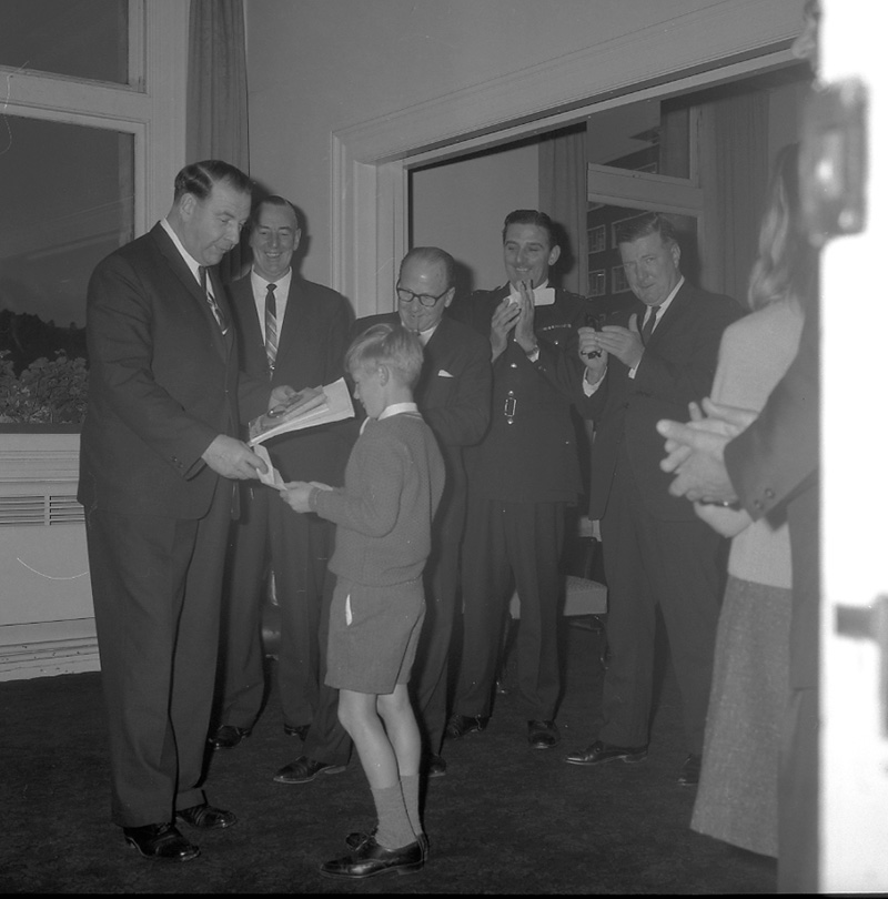 d. Mayor's room, boy presenting plaque to Mayor