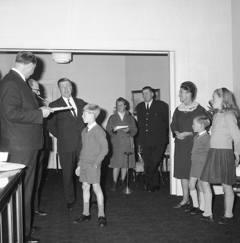 e. Mayor's room, boy presenting plaque to Mayor