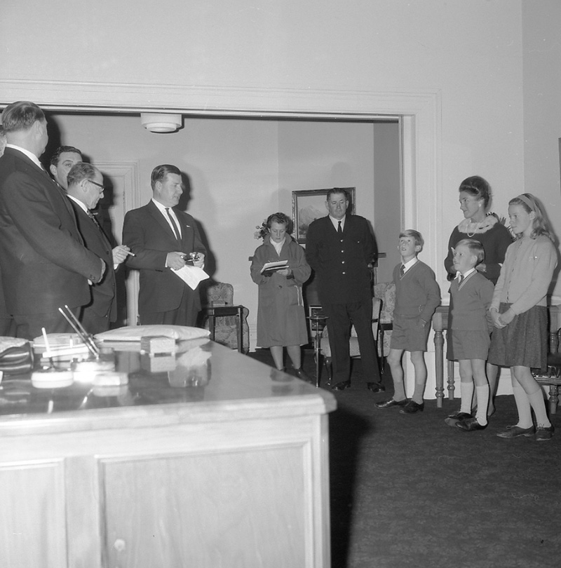 j. Mayor's room, boy presenting plaque to Mayor