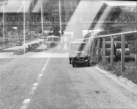 a. Large machine going under railway bridge. Advert for ' Wear Hannah's '