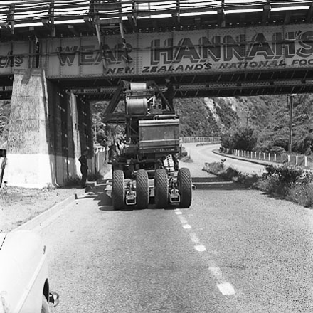 b. Large machine going under railway bridge. Advert for ' Wear Hannah's '