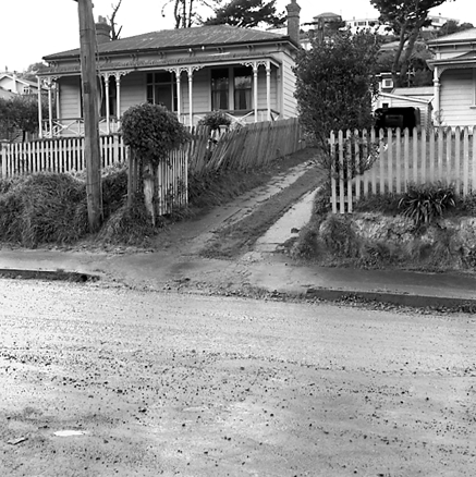 b. Single storey wooden dwellings, footpaths, motorvehicles