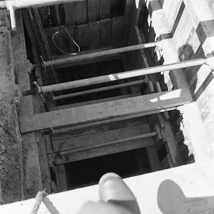 c. Interior of drainage tunnel, workman inside drainage tunnel