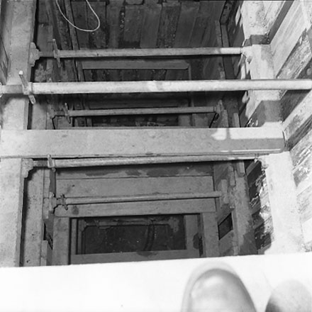 f. Interior of drainage tunnel, workman inside drainage tunnel