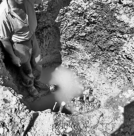 a. Workman standing in hole
