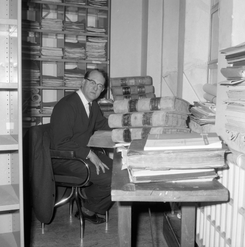 b. George Betts, author, at desk
