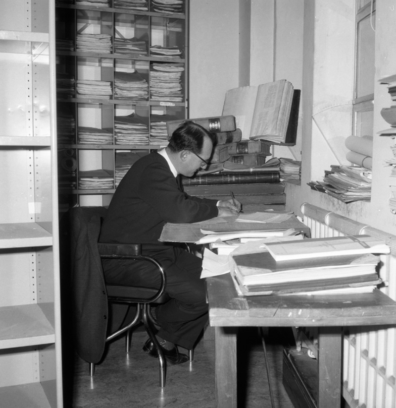 c. George Betts, author, at desk