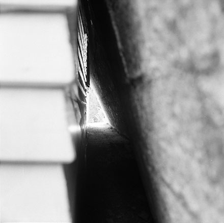 l. Views of dwelling that has been affected by a slip. Concrete retaining wall has fallen over against the house