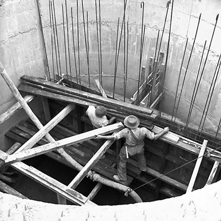 a. Workmen constructing inside of pumping station