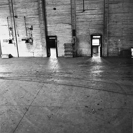 a. Interior of Tram Barns, parked tramcars, motor vehicles, tramlines
