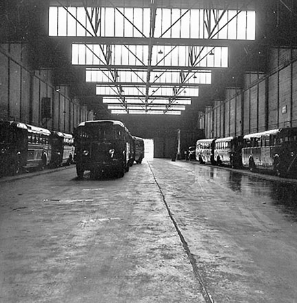 f. Interior of Tram Barns, parked tramcars, motor vehicles, tramlines