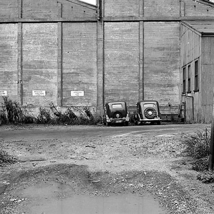g. Interior of Tram Barns, parked tramcars, motor vehicles, tramlines
