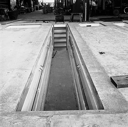 i. Interior of Tram Barns, parked tramcars, motor vehicles, tramlines