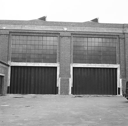 k. Interior of Tram Barns, parked tramcars, motor vehicles, tramlines