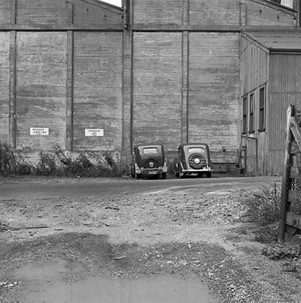 l. Interior of Tram Barns, parked tramcars, motor vehicles, tramlines
