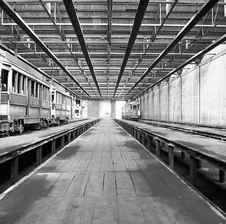 n. Interior of Tram Barns, parked tramcars, motor vehicles, tramlines