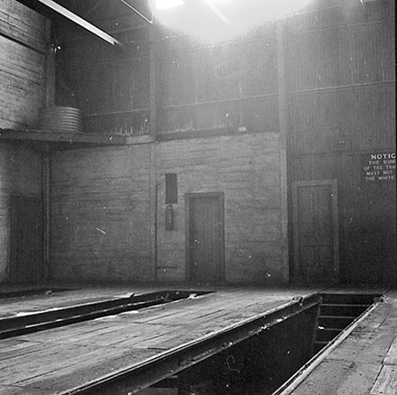p. Interior of Tram Barns, parked tramcars, motor vehicles, tramlines