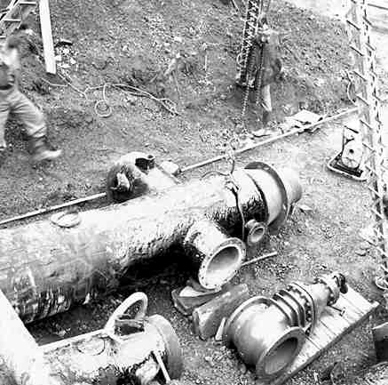 a. Karori Reservoir area, workmen installing pipes