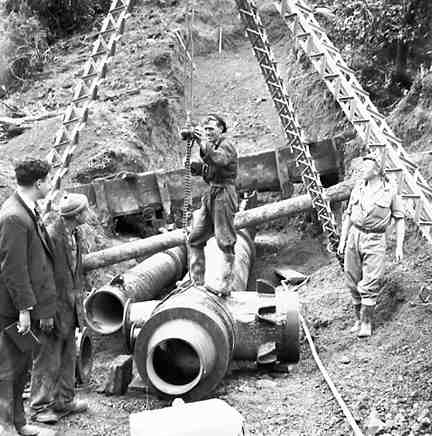 b. Karori Reservoir area, workmen installing pipes