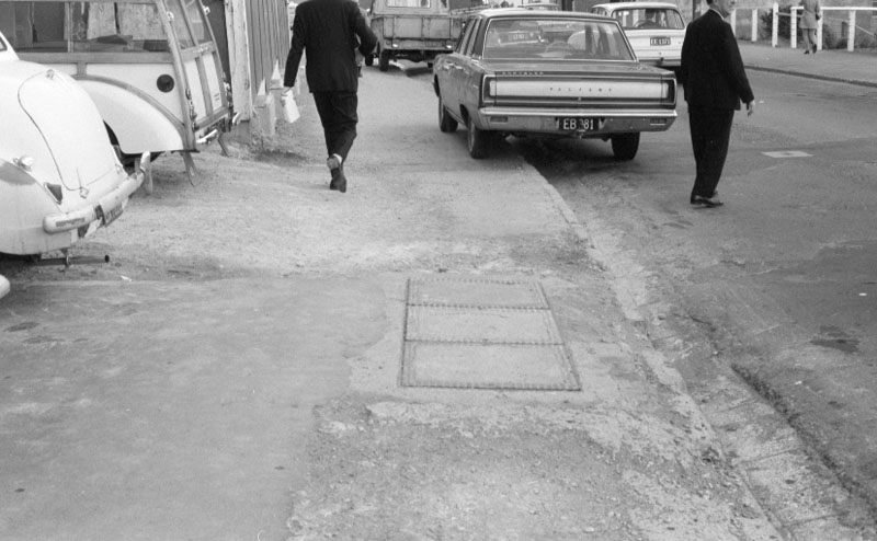 b. Footpaths - various streets. Lombard Street Parking building from Manners St
