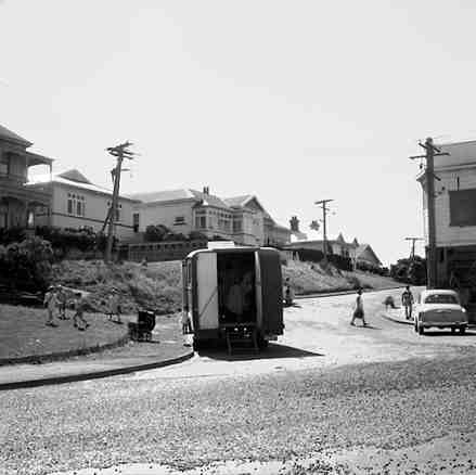 b. Fruit and vegetable sellers van, children are playing on reserve to left