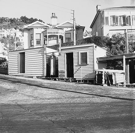 a. Possible repairs to drains in progress. Wellington City Council worksheds, workmen, residential area