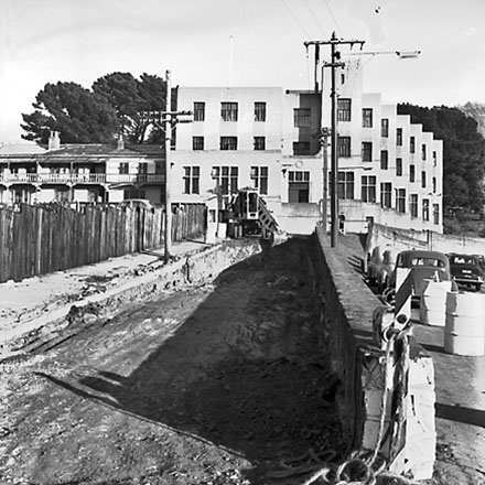 a. Gradall, a long armed front-end digger is being used to excavate the road, May 3rd