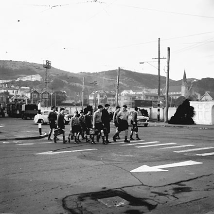 b. Boys from Saint Patricks College crossing road. Buildings of Saint Marks Church School in the background, Ellice Street
