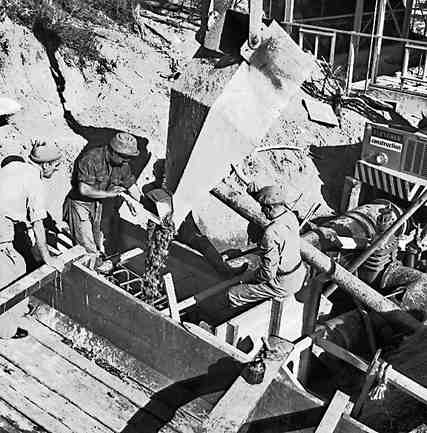 e. Karori Reservoir area, workmen installing pipes