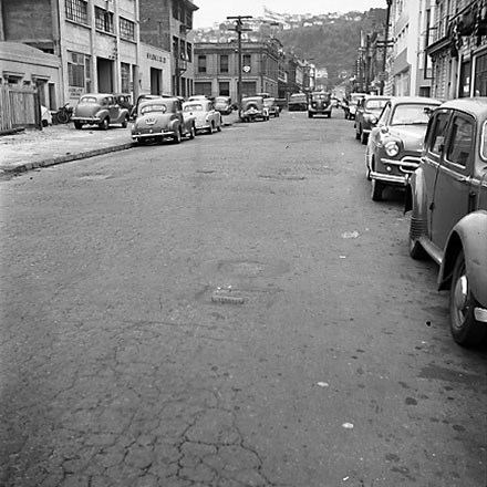 a. Views of streetscape, road surface, road works, machinery, motor vehicles, people, street signs, commercial buildings, Foresters Arms Hotel